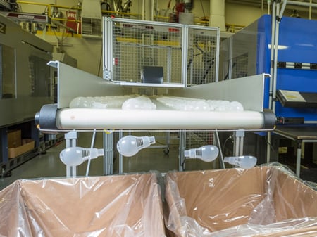 Parts coming out of a plastic injection molding machine.