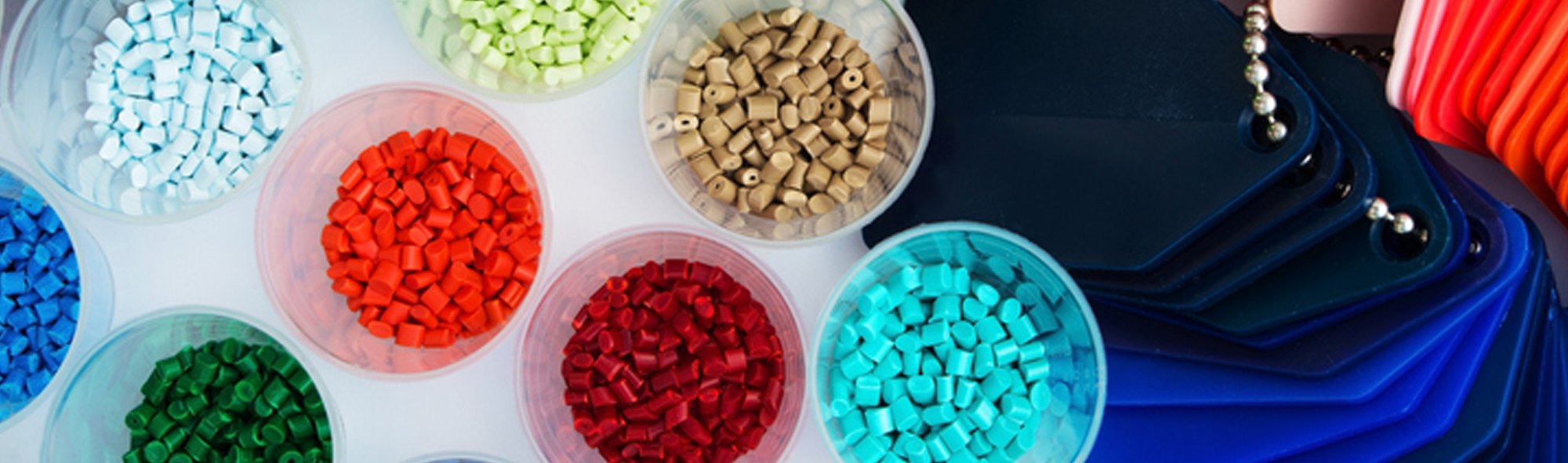 A close-up image of a variety of polymer resin pellets.